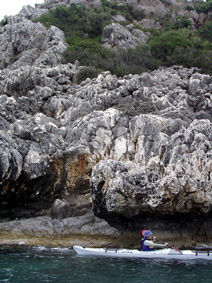 sea kayaking along rocky scenery in Skala tour